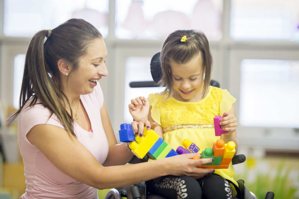 Caregiver And Little Girl Laughing Together Tools To Grow Therapy Caregiver and little girl laughing together tools to grow therapy